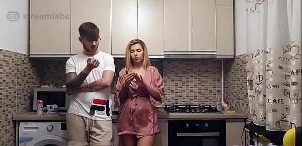  Pretty girl and her boyfriend having fun in kitchen